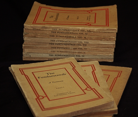 Pamphlets from 'The Fundamentals' stacked on a black background.